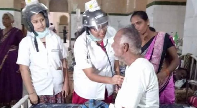 Doctors treating patient wearing helmet in Osmania